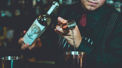 Bartender using a jigger. 